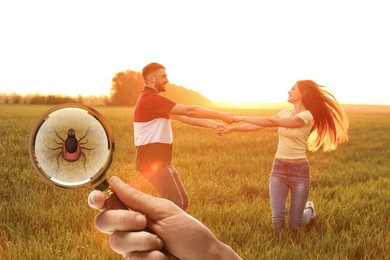 Image of Happy couple spending time together outdoors and don't even suspect about hidden danger in green grass. Woman showing tick with magnifying glass, selective focus