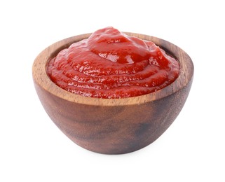 Photo of Organic ketchup in wooden bowl isolated on white. Tomato sauce