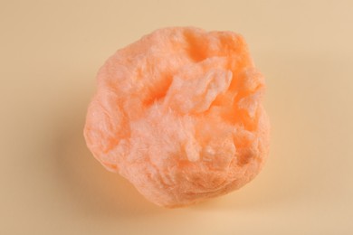 Photo of Sweet orange cotton candy on beige background, top view