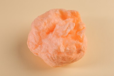 Sweet orange cotton candy on beige background, top view