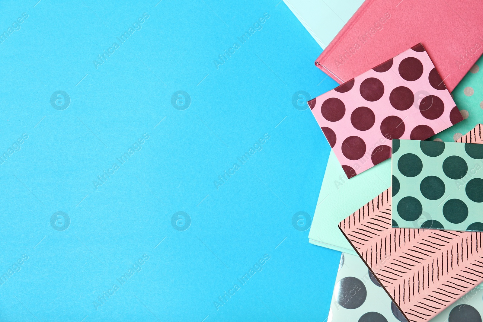 Photo of Flat lay composition with different notebooks on color background. School stationery