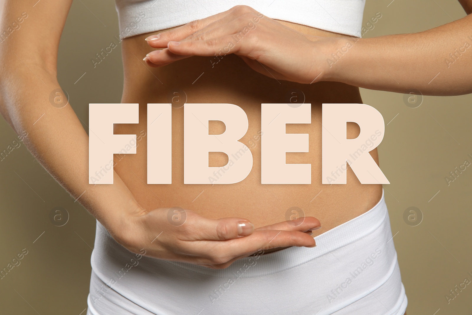 Image of Woman holding hands near belly and word Fiber, closeup