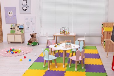 Stylish kindergarten interior with toys and modern furniture