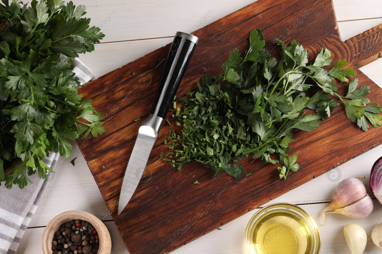 Photo of Fresh green parsley and different products on white wooden table, flat lay