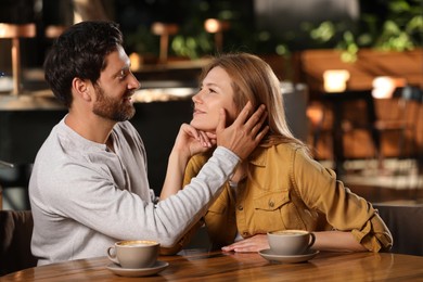 Romantic date. Happy couple spending time together in cafe