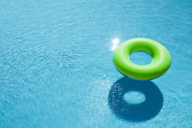 Image of Inflatable ring floating in swimming pool, space for text. Summer vacation