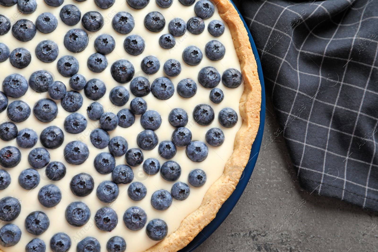 Photo of Flat lay composition with tasty blueberry cake on gray table