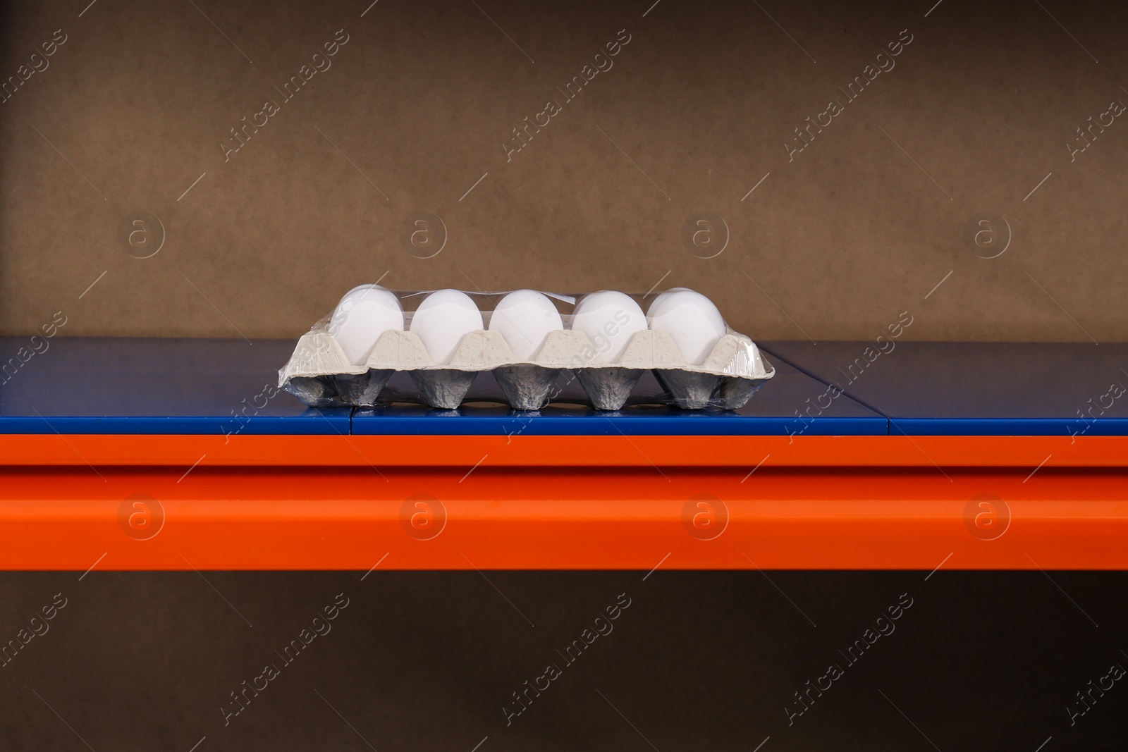 Photo of Tray with chicken eggs on supermarket shelf. Panic during coronavirus pandemic