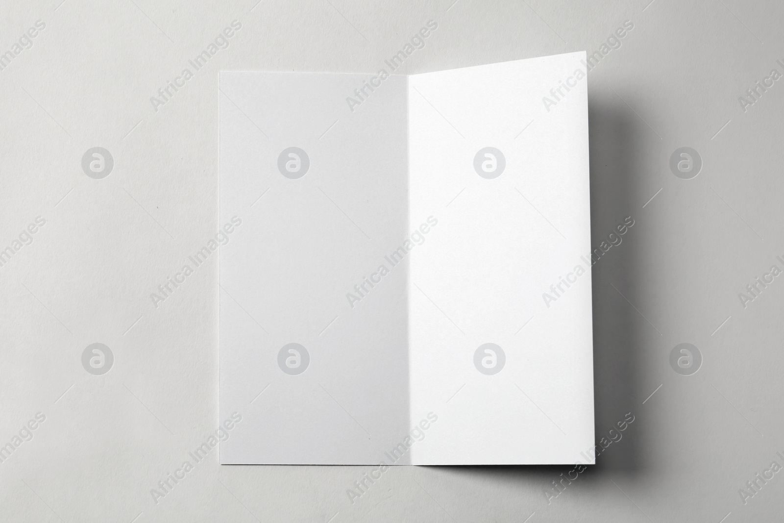 Photo of Blank brochure on white background, above view. Mock up for design