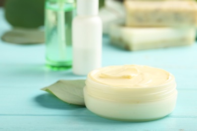 Photo of Jar with cream on wooden background. Hand care cosmetics