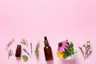 Photo of Bottles of essential oils, different herbs and flowers on pink background, flat lay. Space for text