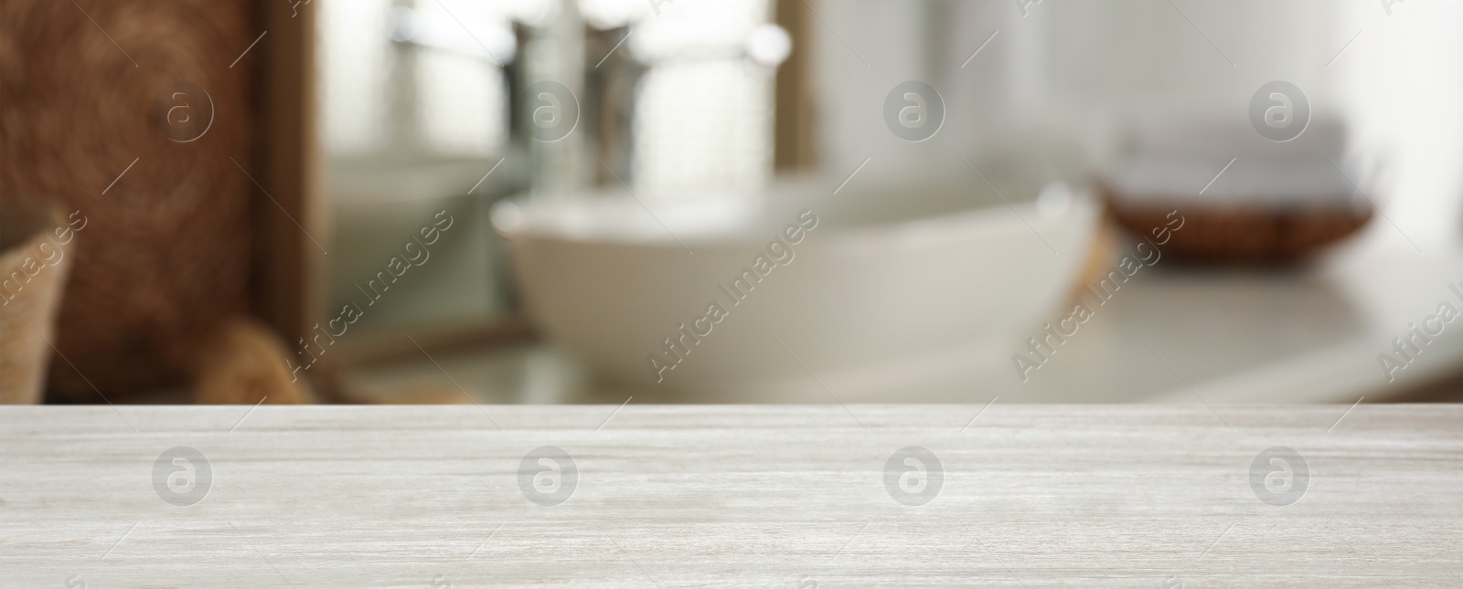 Image of Empty wooden table and blurred view of stylish bathroom interior