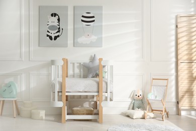 Photo of Baby room interior with stylish furniture and toys