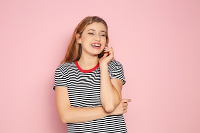 Photo of Portrait of young woman laughing on color background. Space for text