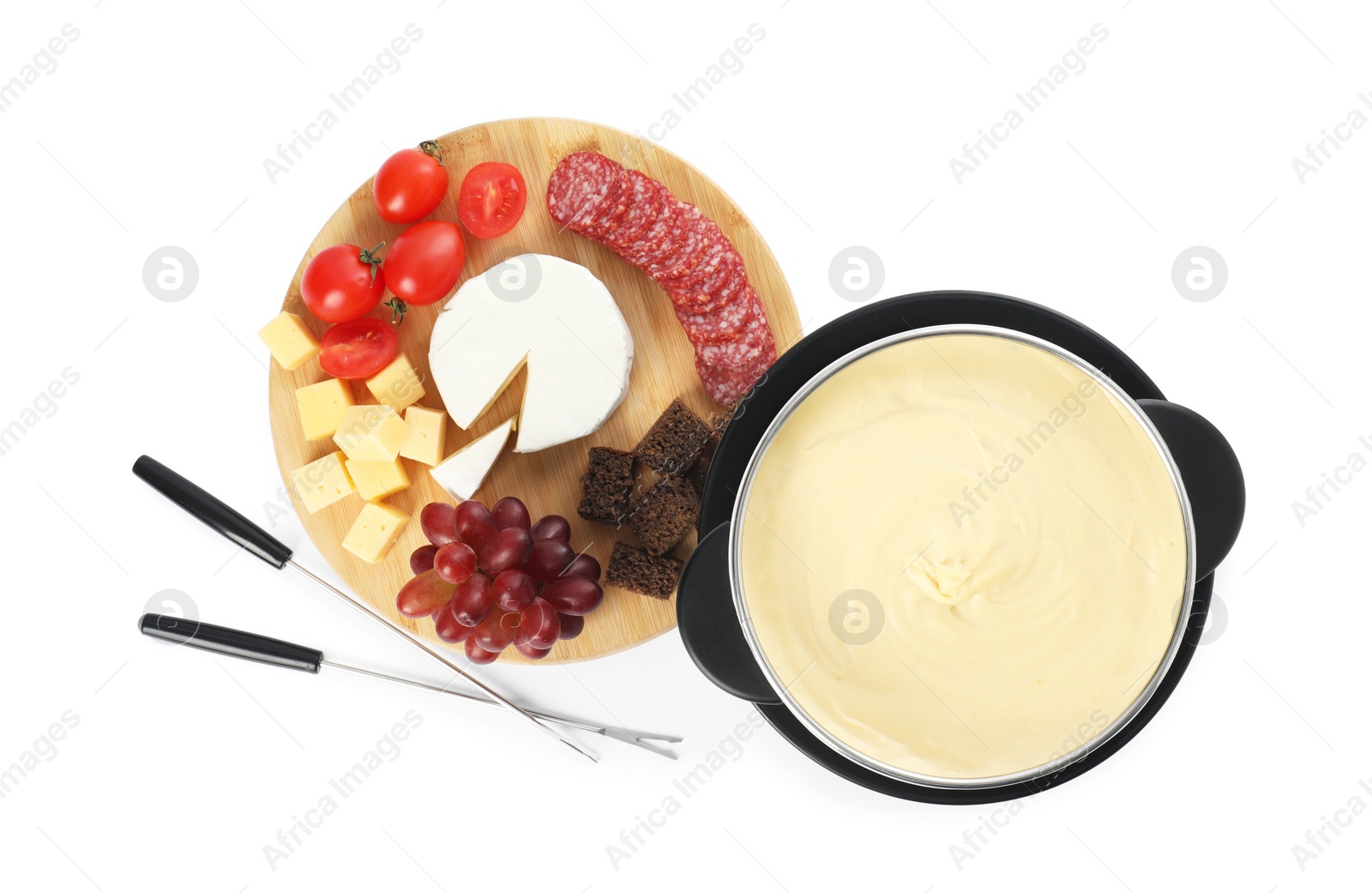 Photo of Fondue with tasty melted cheese, forks and different snacks isolated on white, top view