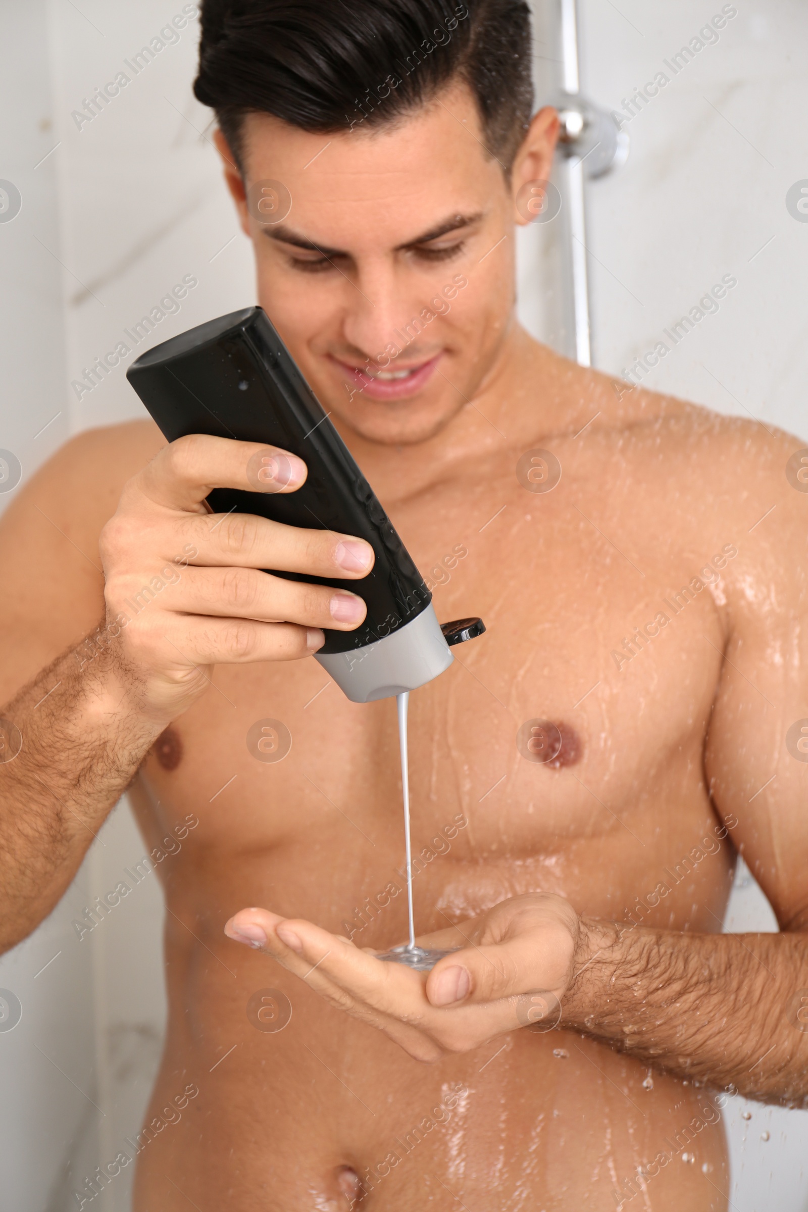 Photo of Man applying gel in shower at home