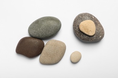 Many different stones on white background, top view