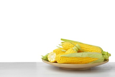 Photo of Tasty corn cobs on wooden table against white background