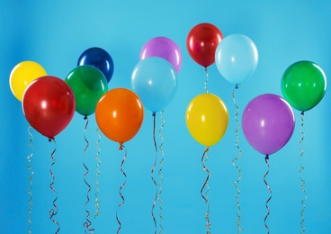 Photo of Bright balloons on color background. Celebration time