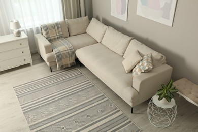 Living room interior with stylish rug and furniture, above view