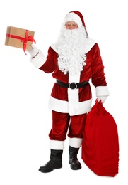Photo of Authentic Santa Claus with sack and gifts on white background