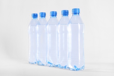 Plastic bottles with pure water on white background