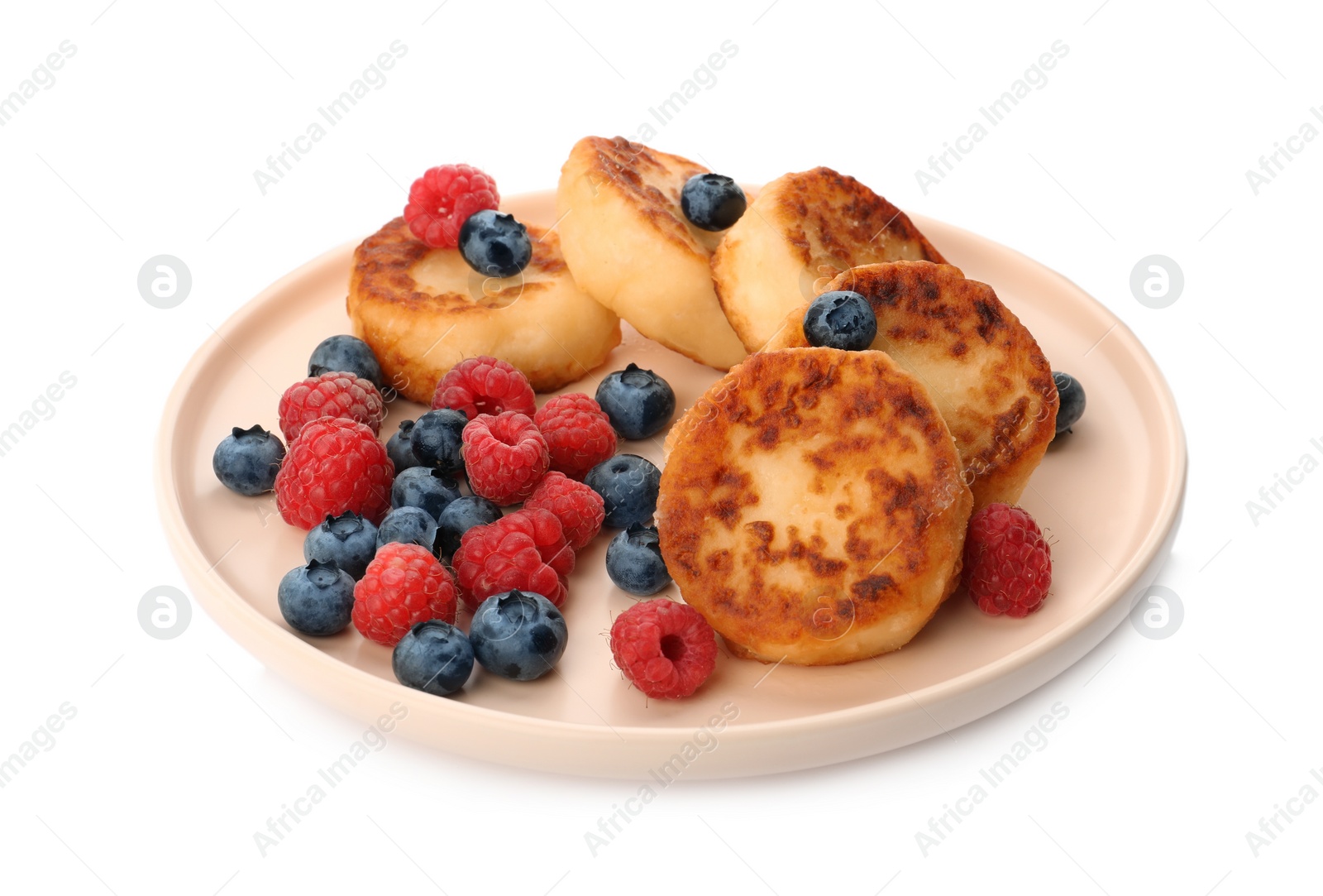 Photo of Plate with delicious cottage cheese pancakes and fresh berries on white background