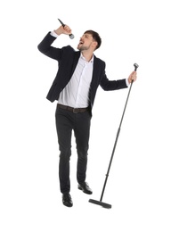 Photo of Handsome man in suit singing with microphone on white background