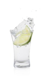 Photo of Vodka splashing out of shot glass with lime on white background