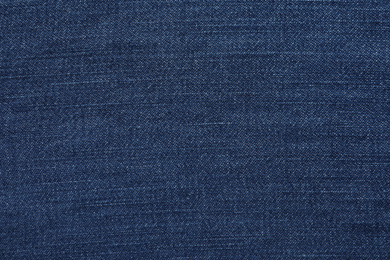 Photo of Texture of dark blue jeans as background, closeup