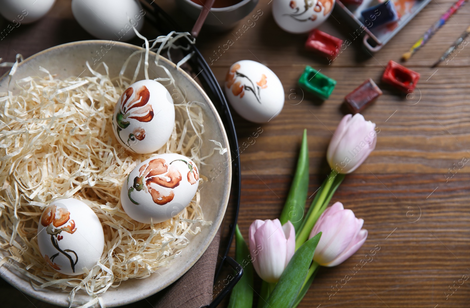 Photo of Flat lay composition with painted Easter eggs on wooden table