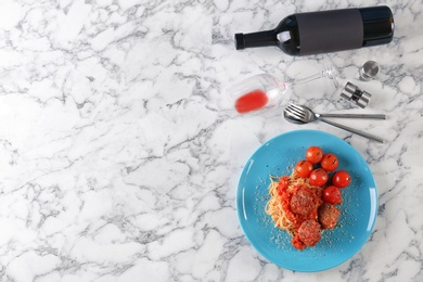 Delicious pasta with meatballs and tomato sauce on light background, flat lay