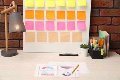 Business process planning and optimization. Workplace with colorful paper notes and other stationery on table