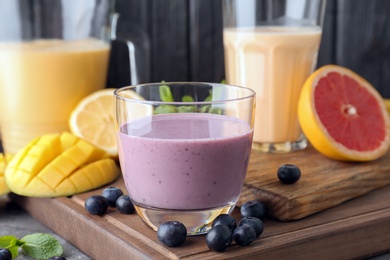 Glassware with healthy detox smoothies and ingredients on table