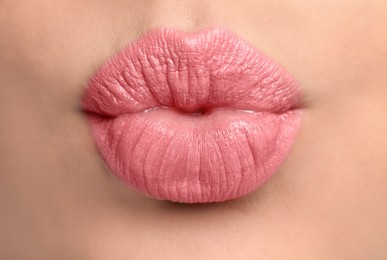 Photo of Closeup view of beautiful woman puckering lips for kiss