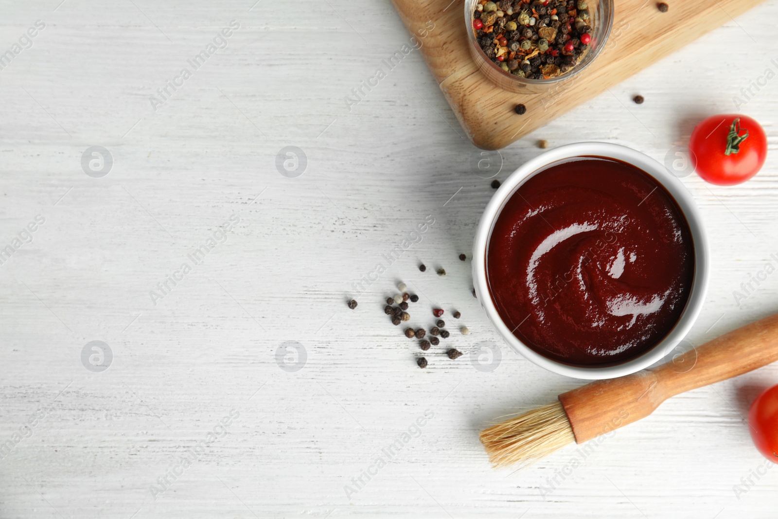 Photo of Flat lay composition with barbecue sauce on white wooden background. Space for text