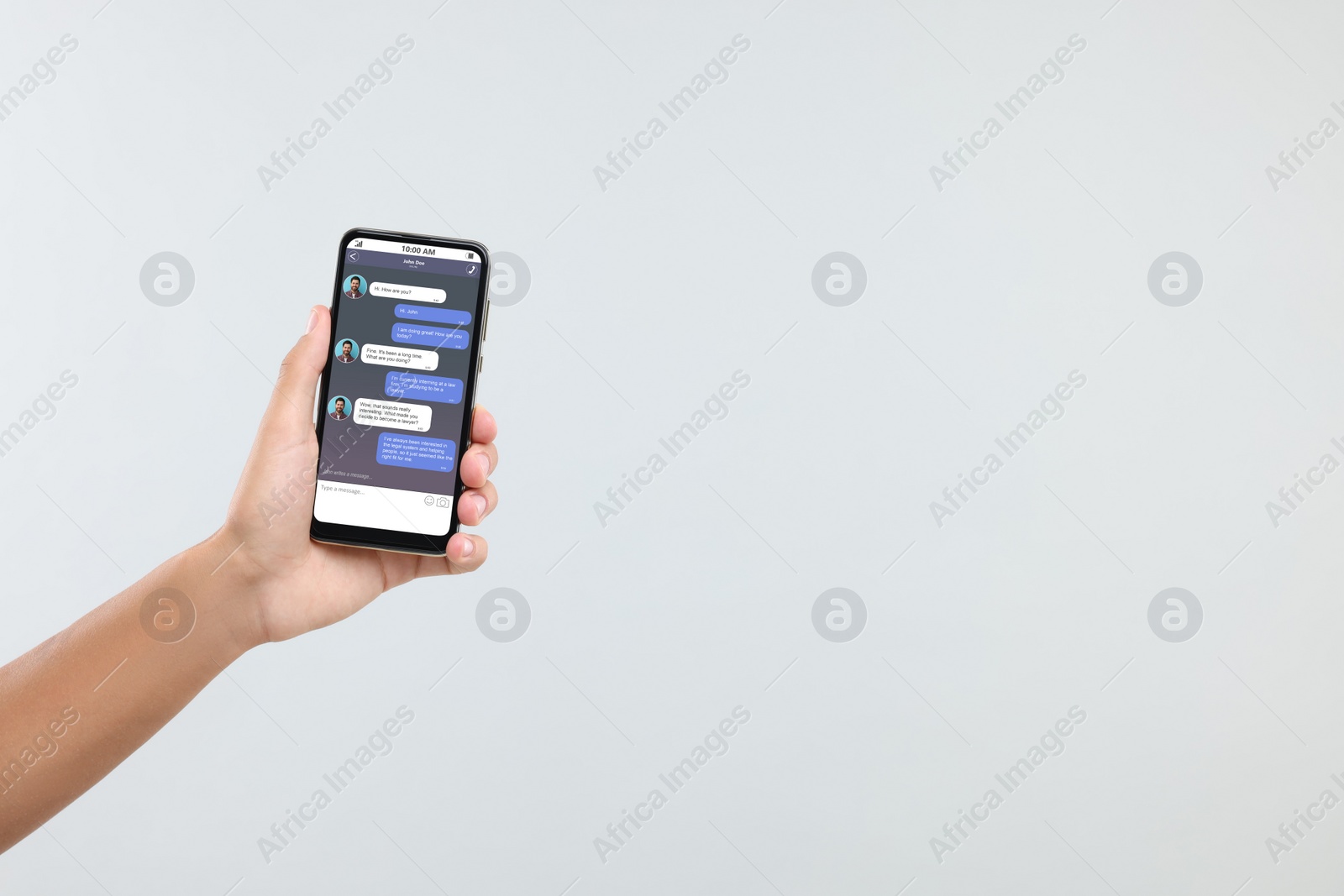 Image of Man texting with friend using messaging application on smartphone against light grey background, closeup. Space for text