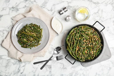 Photo of Yummy green beans with almonds served for dinner on table, flat lay