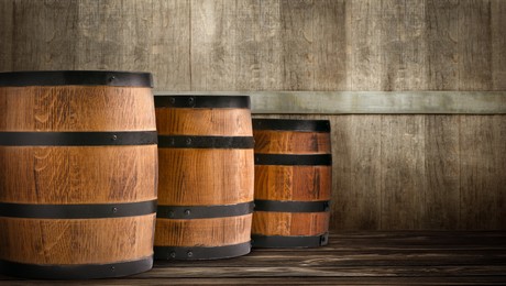 Barrels on wooden background, space for text. Banner design