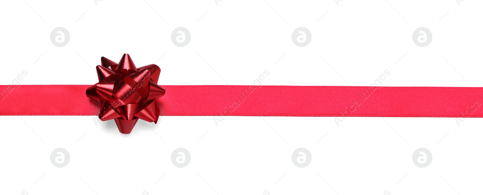 Photo of Red ribbon with bow on white background, top view