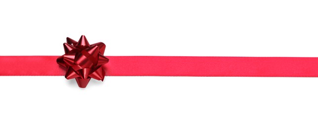 Photo of Red ribbon with bow on white background, top view