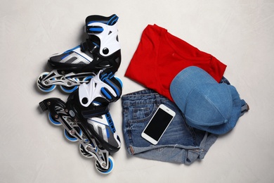 Flat lay composition with inline roller skates on light background