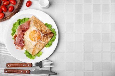 Photo of Delicious crepe with egg served on white tiled table, flat lay with space for text. Breton galette