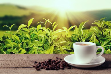 Cup of aromatic hot coffee on wooden table and beautiful view of mountain landscape. Space for text