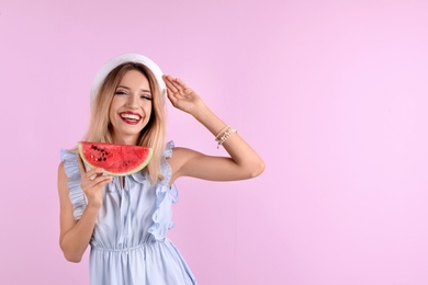 Photo of Pretty young woman with juicy watermelon on color background