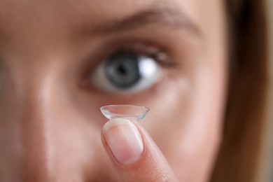 Photo of Young woman with contact lens, closeup view