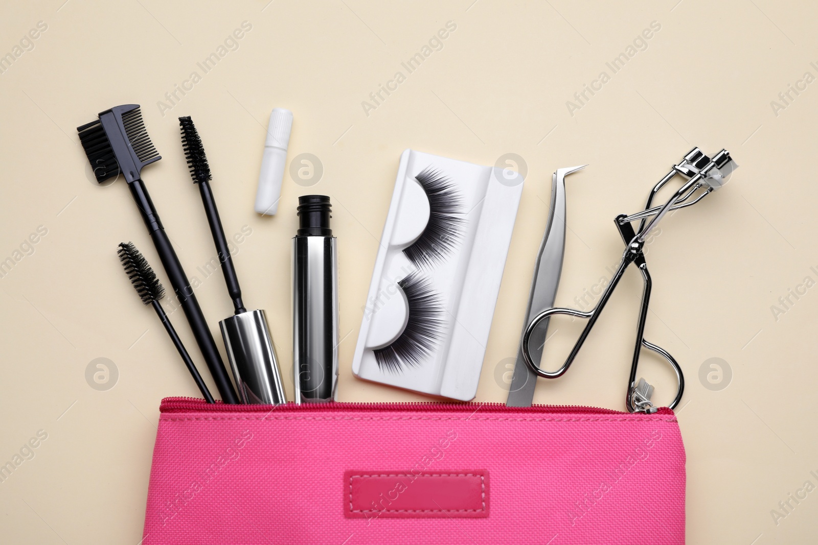 Photo of Flat lay composition with fake eyelashes on beige background