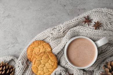 Composition with delicious hot cocoa drink and cookies on grey background, flat lay