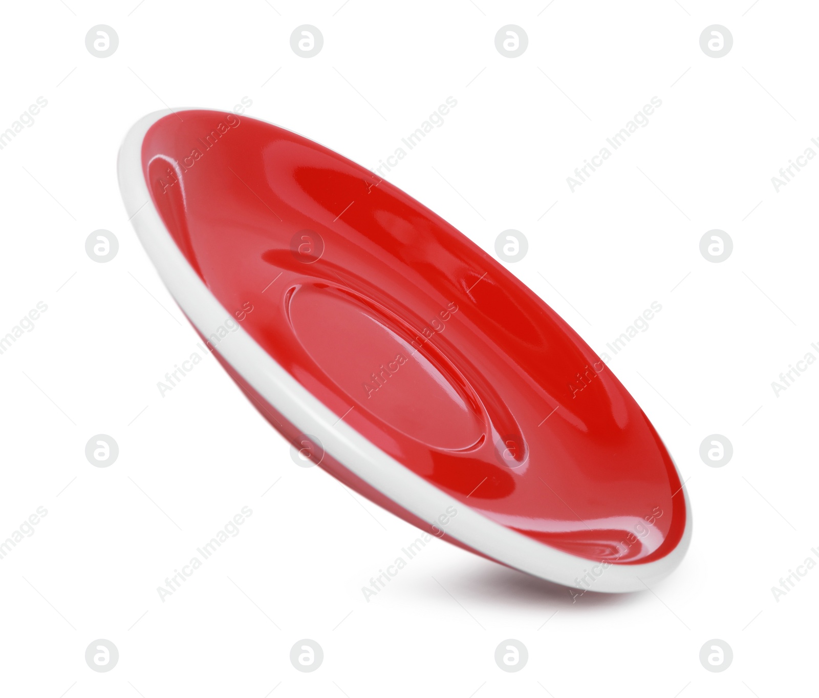 Photo of One red ceramic saucer isolated on white