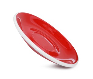Photo of One red ceramic saucer isolated on white